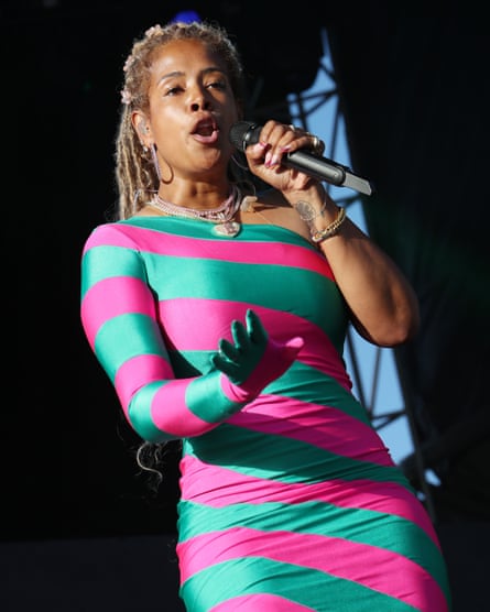 woman performs with handheld mic onstage