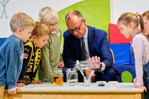 Friedrich Merz observes an experiment with children at a kindergarten