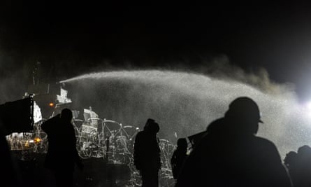 Police spray water on protesters during the night of 20 November.
