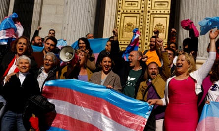 Spain’s minister for equality, Irene Montero, centre, celebrates with LGBTQ+ activists after a new transgender law was passed