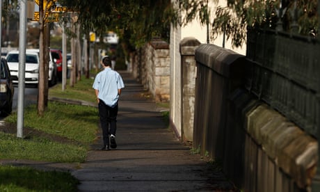 Teen schoolboy walking down street alone