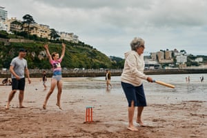 A family play cricket on Torquay beach