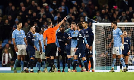 The Manchester City players have their say as the referee points for a corner flag not a penalty after a VAR check for handball against Chelsea.