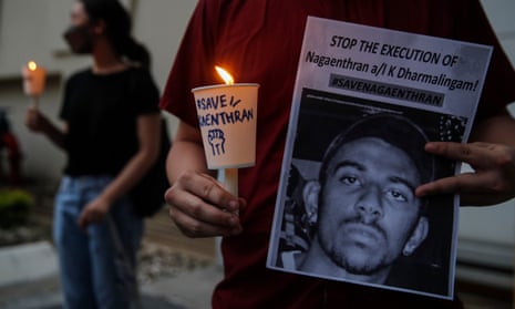 An activist holds a placard with candle during a vigil for Nagaenthran K Dharmalingam