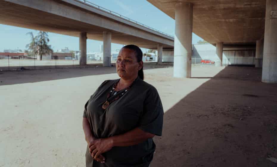 Woman stands for portrait under road underpass