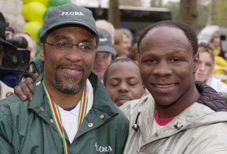 Michael Watson is congratulated by Chris Eubank after crossing the finish line in the 2003 London Marathon.