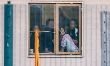 Women look out from a window in Yarl’s Wood immigration removal centre in Bedfordshire