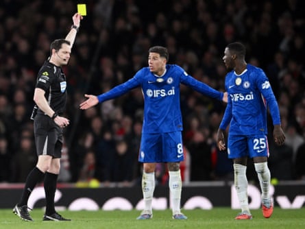 Enzo Fernández (centre) is booked in the Premier League match between Arsenal and Chelsea