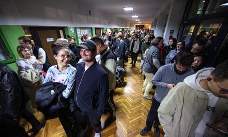 A queue of people waiting to vote in front of the seat of district electoral commission No. 124 in Krakow, Poland, 15 October 2023.