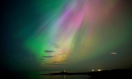 The aurora borealis, also known as the northern lights, glow on the horizon at St Mary’s Lighthouse in Whitley Bay