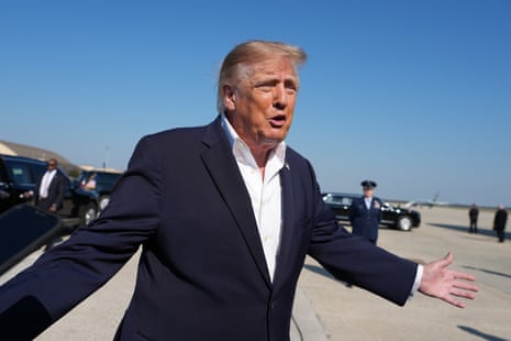 President Trump gestures with open arms on the tarmac before boarding Air Force One