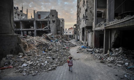 A child walks among destroyed buildings in Rafah, Gaza, on 21 December 2023.