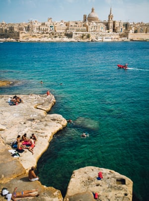 Views sweep across saturated-blue Mediterranean Sea under periwinkle skies