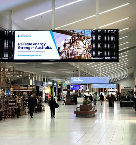 An ad on a digital billboard, seen in an airport