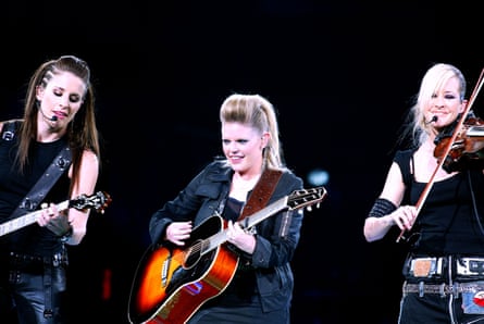 The Chicks performing on stage with guitars and a violin