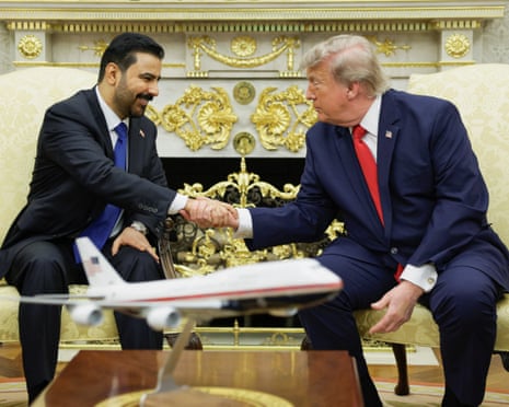 Donald Trump shakes hands with Ali al-Zaidi as they participate in a bilateral meeting in the Oval Office.