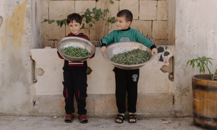 Palestinian children show their produce.