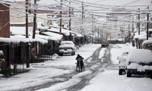 A man rides on a bicycle as it snows in Ciudad Juárez