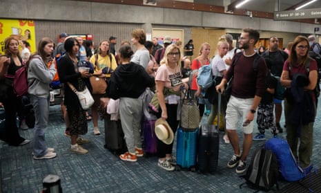 People queue as they wait to leave the island.
