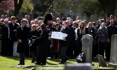 Mourners watch as the coffin of the unknown baby boy is carried to his graveside at Seafield cemetery in Edinburgh.