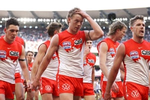 Callum Mills holds his head as the Swans leave the field at half-time.
