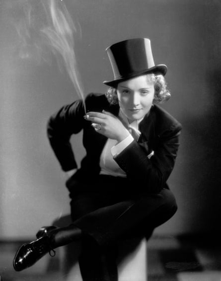 Marlene Dietrich making her Hollywood film debut wearing a tuxedo and top hat and while smoking, in the film Morocco.