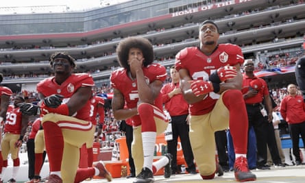 Kaepernick, centre, and San Francisco 49ers teammates protesting in 2016