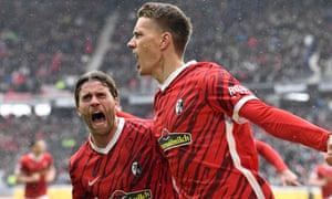 Freiburg’s German forward Nils Petersen (R) and Freiburg’s German forward Lucas Hoeler celebrate after scoring .