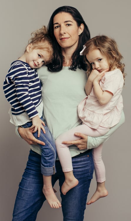 Emma Brockes holding her twin daughters