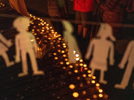 Hundreds of candles and simple paper cut-outs representing missing children