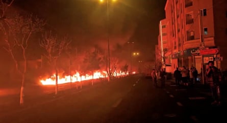 Fire burns along Tehran’s Koohsar Boulevard, Iran, at night on 8 March 2026.