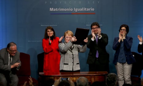 Chile’s president, Michelle Bachelet, holds a portfolio with her signed proposal for a same-sex marriage bill.