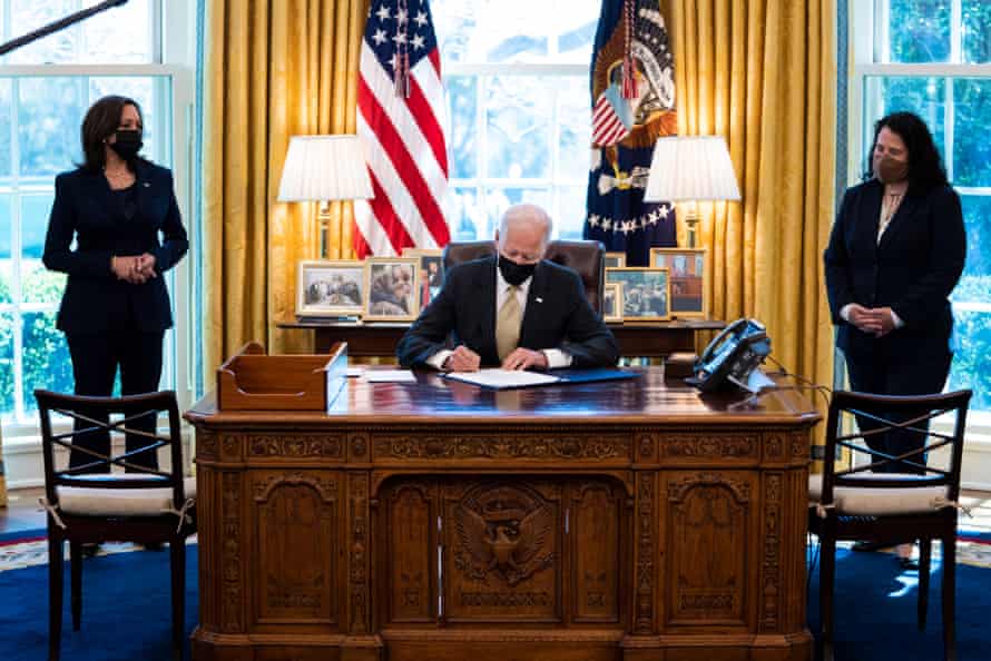 Joe Biden signs the PPP Extension Act of 2021 into law in the Oval Office.