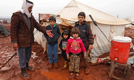 A man and his children at a camp for internally displaced people in Batabu, Syria, January 2018.