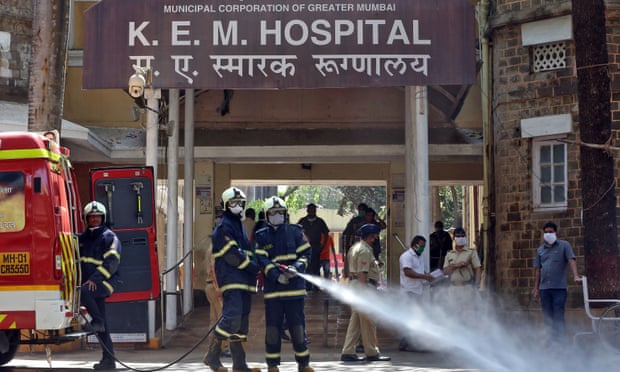 Firefighters disinfect the grounds of a hospital in Mumbai