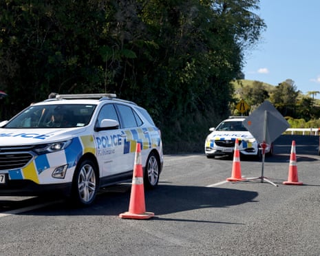 Police cars arrive at a roadblock where the exchange of fire took place near the town of Piopio in New Zealand's Waikato region