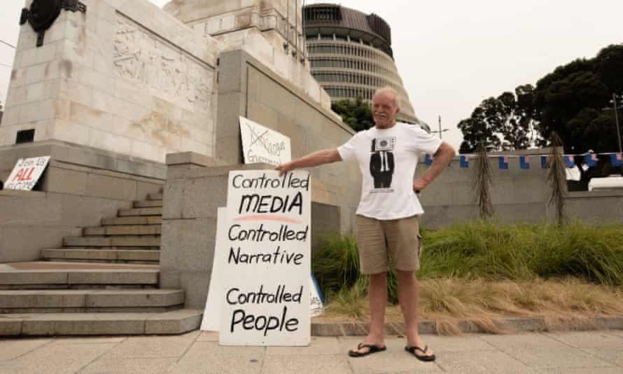 man stands with sign