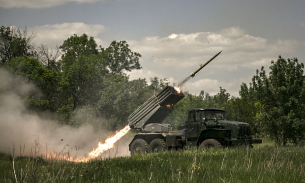 Ukrainian troops fire rockets towards Russian positions at a frontline in the Donbas region.