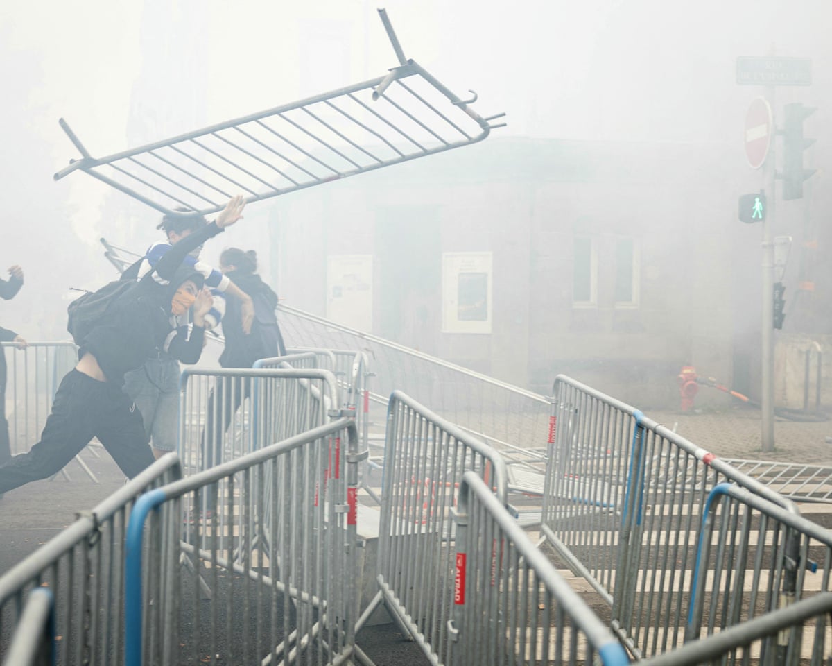 A student drops a barrier as students carry out a blocking protest at the Strasbourg University, in Strasbourg, eastern France.