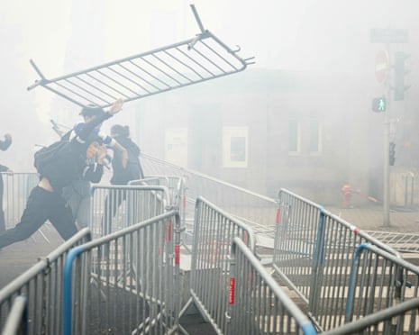 A student drops a barrier as students carry out a blocking protest at the Strasbourg University, in Strasbourg, eastern France.