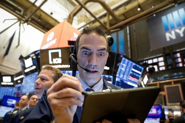 Traders on the floor at the New York Stock Exchange tonight