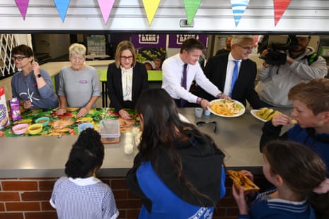 Victorian premier Jacinta Allan (centre) serves students breakfast at Ascot Vale West primary school in Melbourne