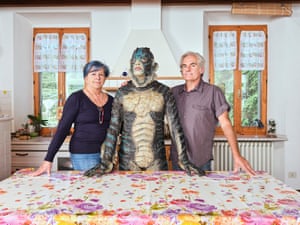 Andrea (23) poses with his parents in the kitchen of their home in Cesena, Emilia Romagna, Italy by Niccolo Rastrelli