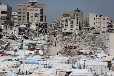 Tents amid the rubble of destroyed buildings