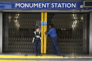 London Underground workers shut the gates at Monument station