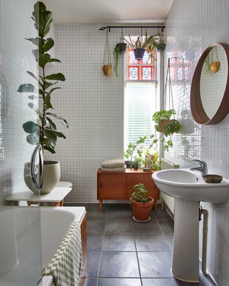 Clean lines: stained-glass windows, plants in the white-tiled bathroom.