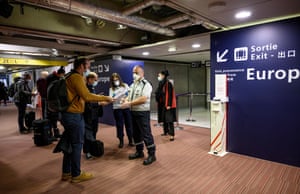 Red Cross (Croix Rouge) officials check whether incoming international flight passengers have paperwork certifying that they have had PCR tests for coronavirus (Covid-19) at Roissy-Charles de Gaulle Airport, north-east of Paris on 13 February, 2021, to enable them to enter French territory.