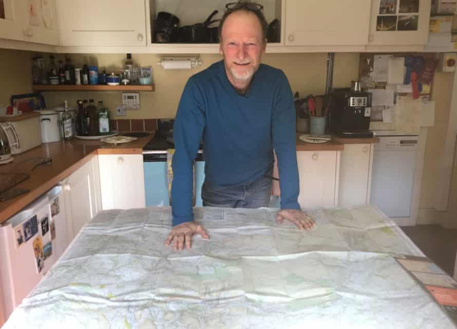 Kevin Rushby studying his OS map at home in Wales.
