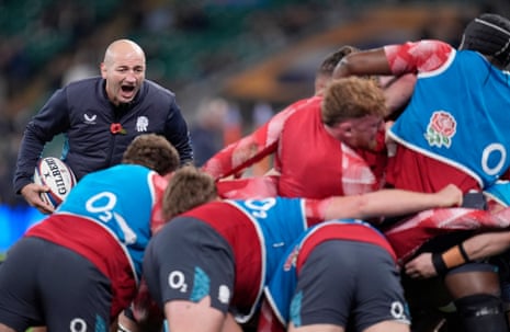 England head coach Steve Borthwick (left) gives instructions to his players during the warm-up.