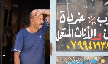 Ahmed Saeed Abu Fares leans against a window